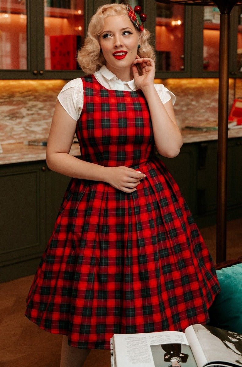 Model wears our sleeveless Annie dress in red, with blue checks, with white shirt and accessories