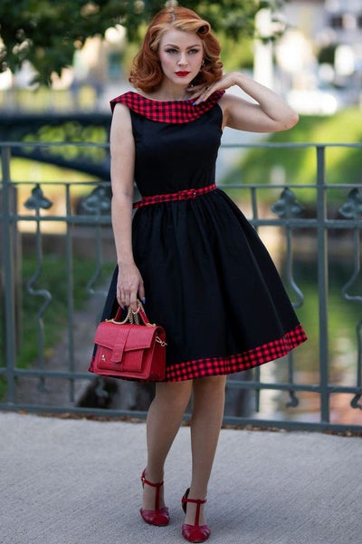 Model wearing black swing dress with red tartan 50's roll collar