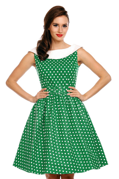 Model wearing our Cindy sleeveless dress, in green/white polka dot print, close up view