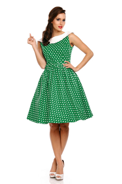 Model wearing our Cindy sleeveless dress, in green/white polka dot print, front view