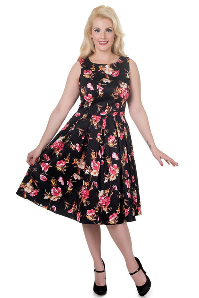 Model wearing our sleeveless Annie dress in black/pink floral print, front view