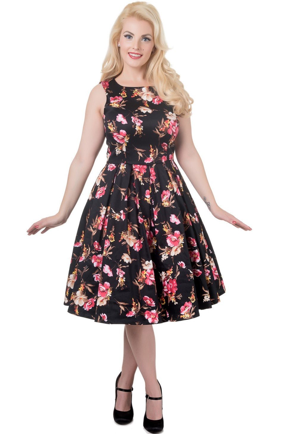 Model wearing our sleeveless Annie dress in black/pink floral print, front view