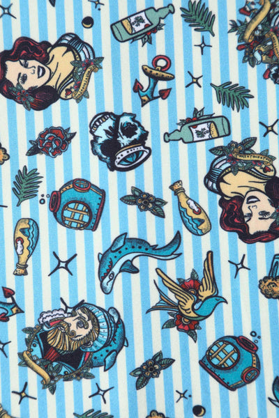Blue striped fabric, with sea themed tattoo print close up