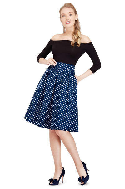 Model wears our black top and dark blue polka dot flared skirt, front view