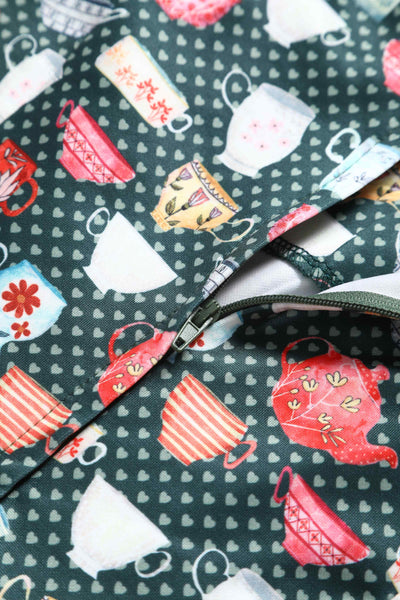 Close up View of Teacup and Teapot Pring Sleeveless Swing Dress in Green