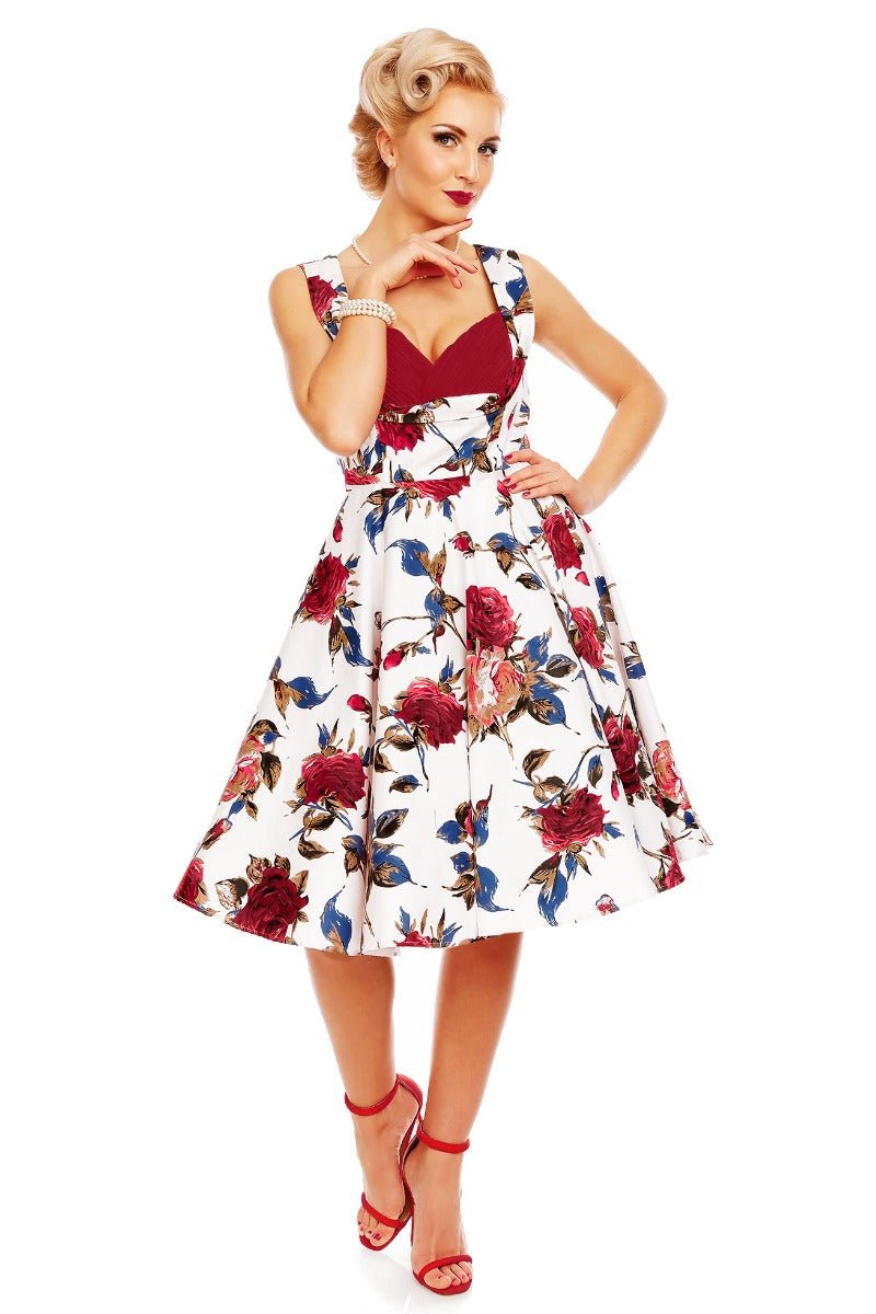 Model wearing Grace pleated bust dress, in white, with red roses, front view