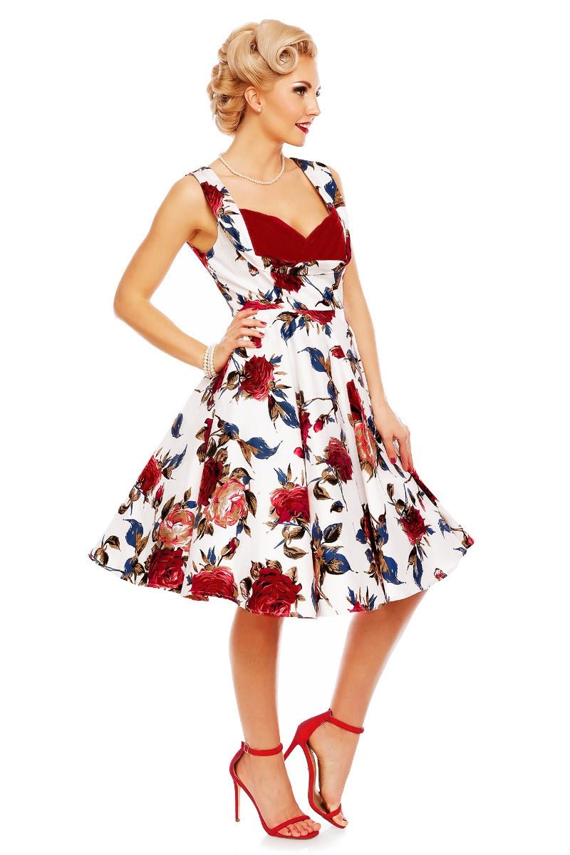 Model wearing Grace pleated bust dress, in white, with red roses, side view