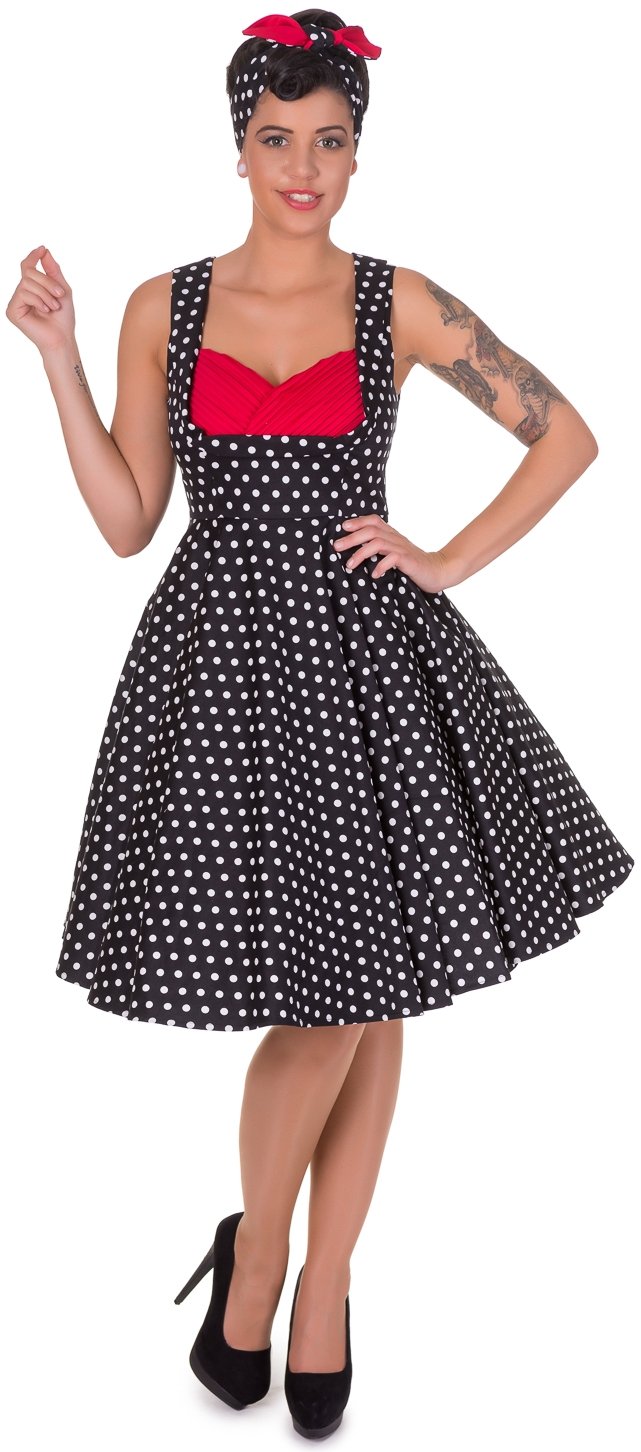 Model wearing our Grace sleeveless dress, in black, with white polka dots, front view