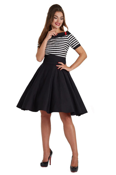 Model wears our bateau neckline Darlene dress, in black and write stripes, front view