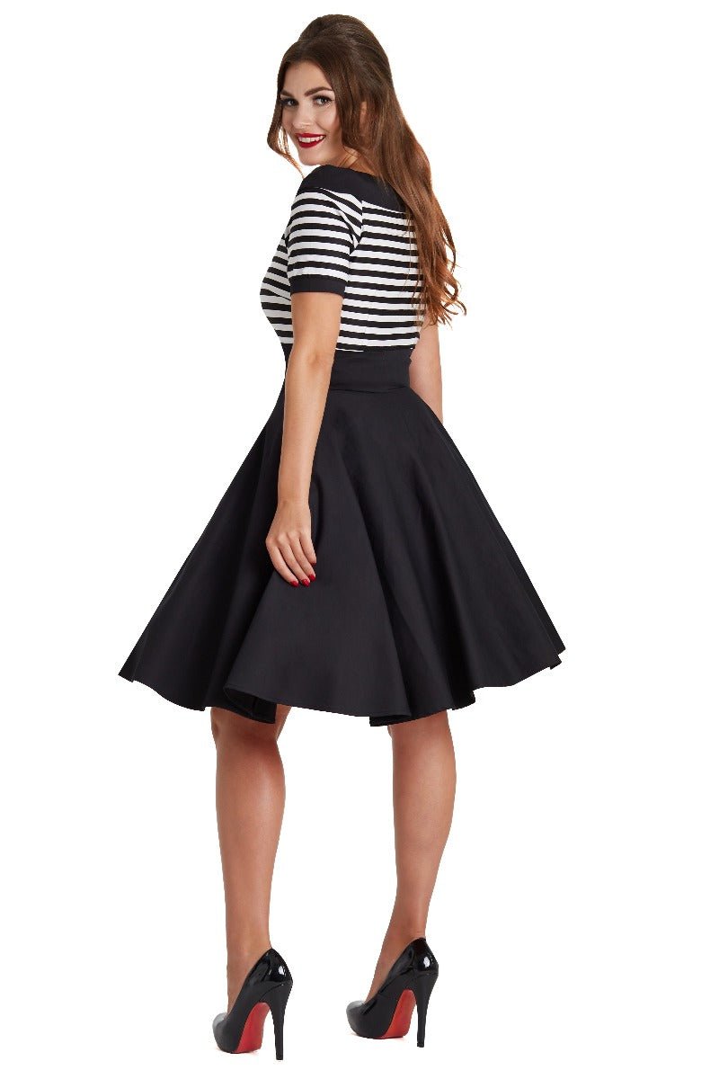 Model wears our bateau neckline Darlene dress, in black and write stripes, back view