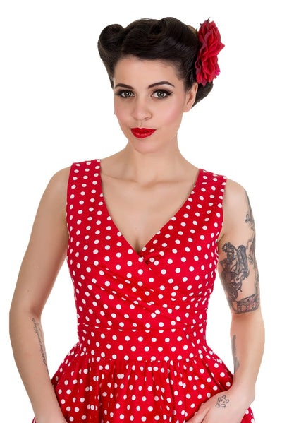Model wearing our May crossover bust dress, in red/white polka dot print, close up view