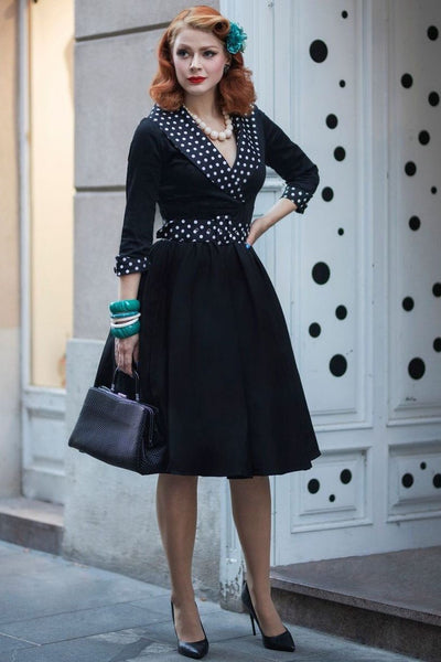 Model wearing black white polka dot collared swing dress