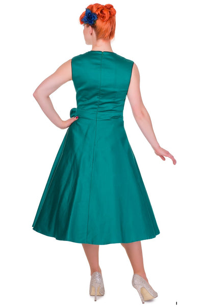 Model wearing our green Harriet dress, with bow, back view