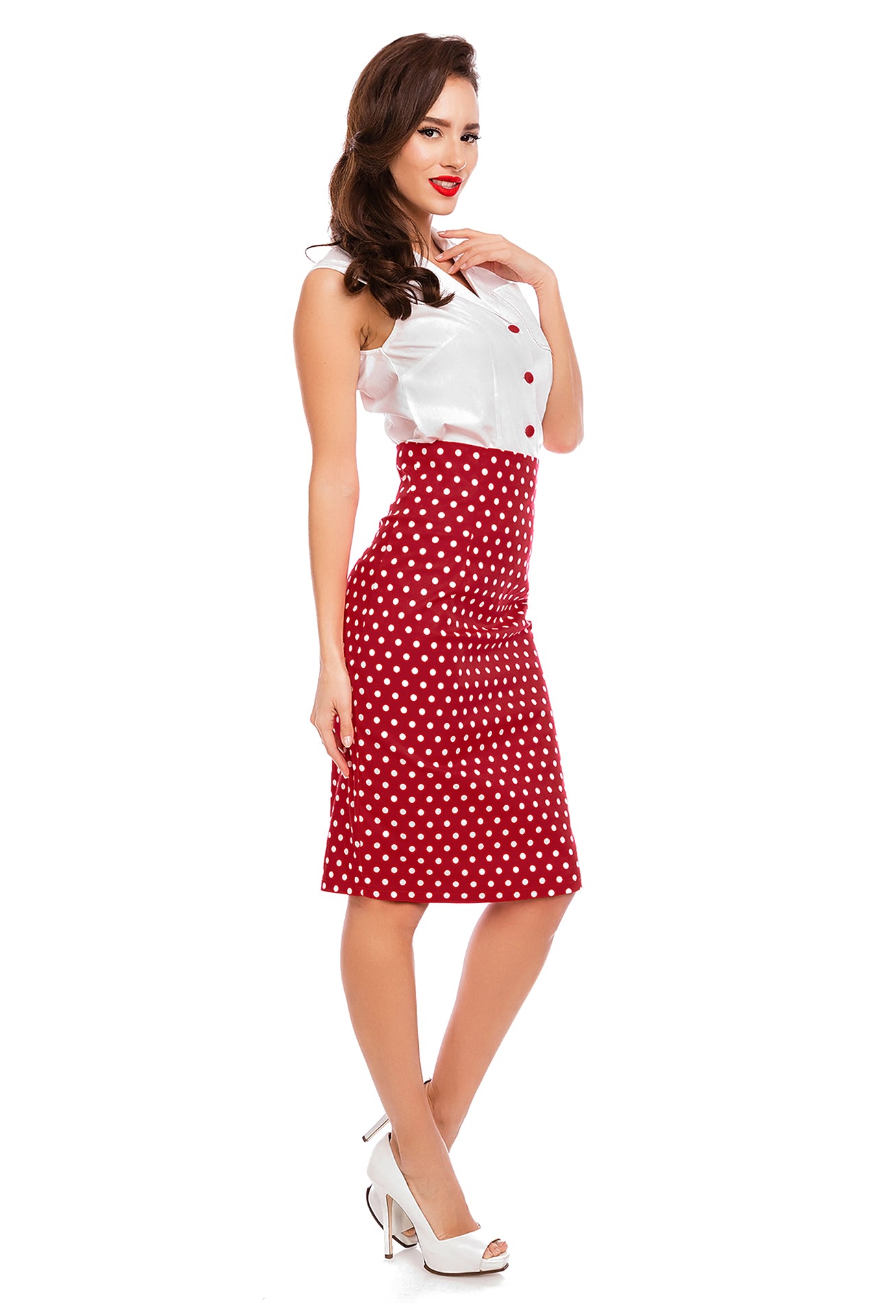 Model wearing our red and white polka dot pencil Falda skirt, with white top, side view