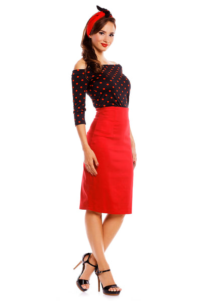 Model wearing our Gloria Rockabilly Top in Black/Red Polka Dots, with red skirt and headband, side view