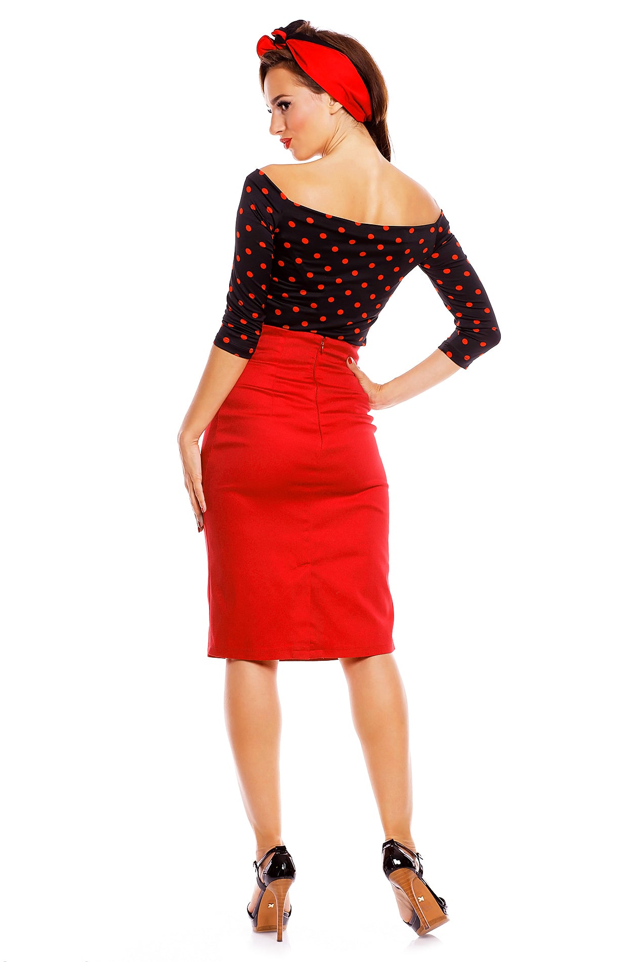 Model wearing our Gloria Rockabilly Top in Black/Red Polka Dots, with red skirt and headband, back view
