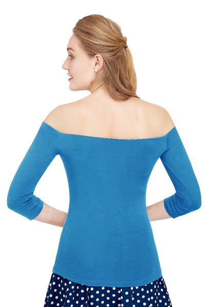 Model wears our off-shoulder, long sleeved top, in blue, back view