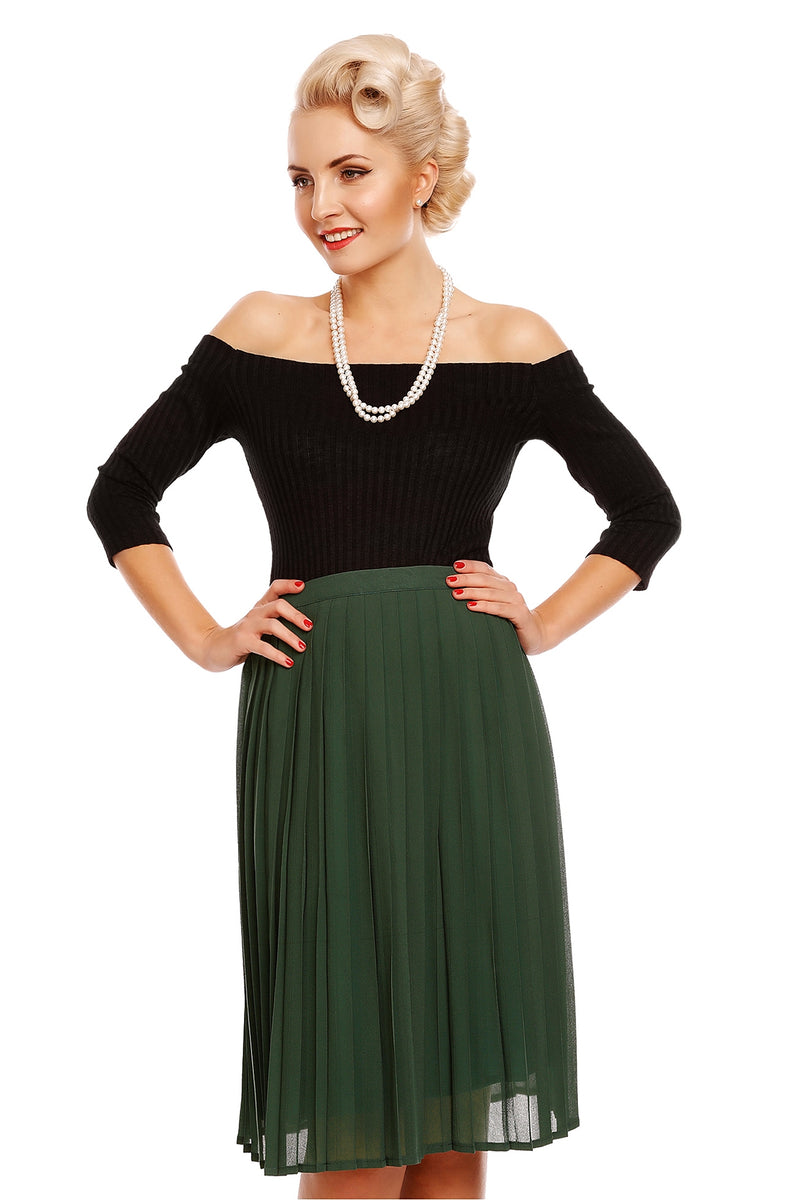 Model wearing our Gloria off-shoulder long sleeve top in black, with a green skirt, front view
