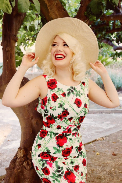 Woman wearing our Naomi Floral Rose Wiggle Dress in White/Red, in front of a tree