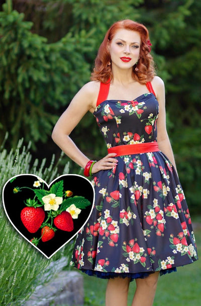 Model wears the Sophia halterneck dress, in black, with red strawberries and white flowers, with petticoat, front view