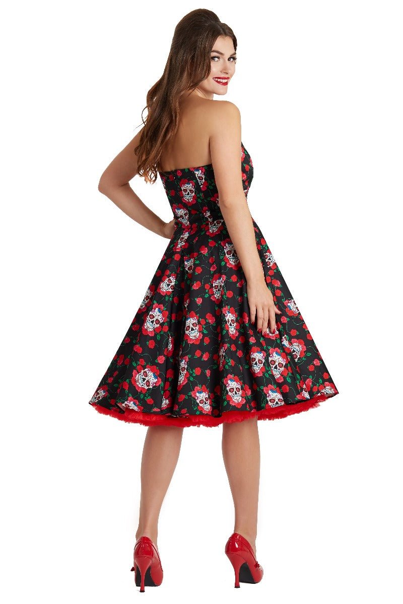 Model wearing the strapless Melissa dress, in black, with red roses and white sugar skulls, back view