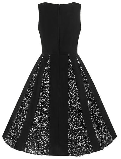 Judith sleeveless dress, in black, with white polka dots on alternate skirt panels, back view