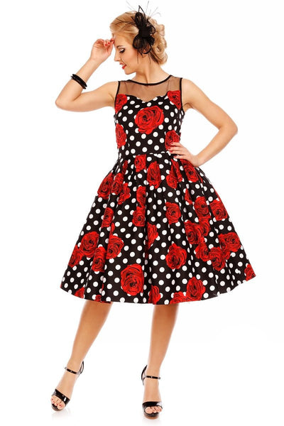 Model wearing our Elizabeth black party dress, with red roses and white spots, front  view