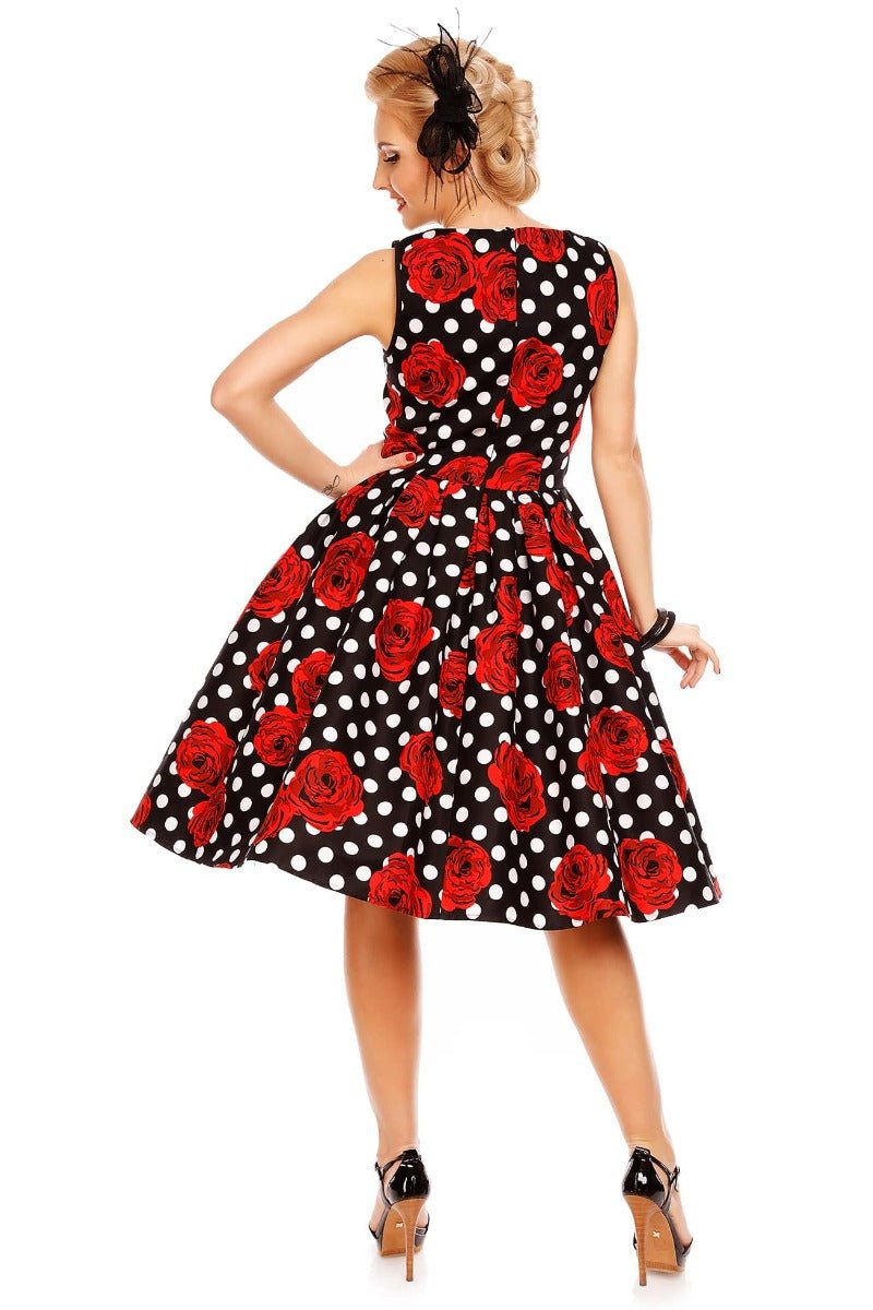 Model wearing our Elizabeth black party dress, with red roses and white spots, back view