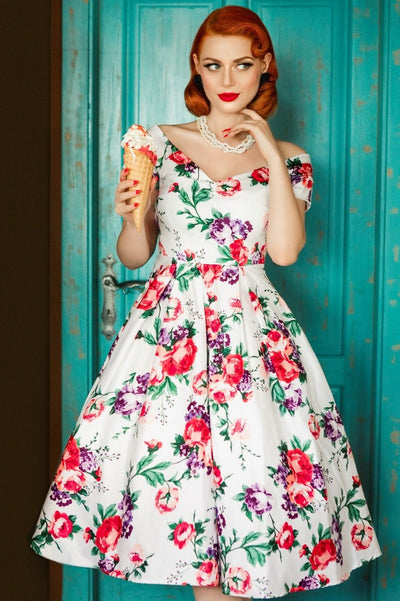 Model wearing our Lily, off-shoulder 50's Evening Dress in White, with pink and purple flowers