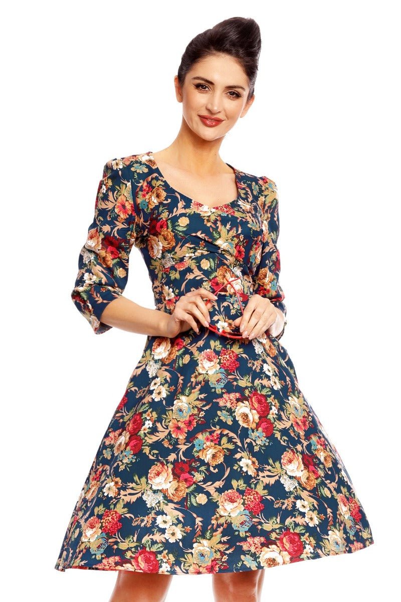 Model wearing our Katherine long sleeved swing dress, in dark blue/red floral print, front view