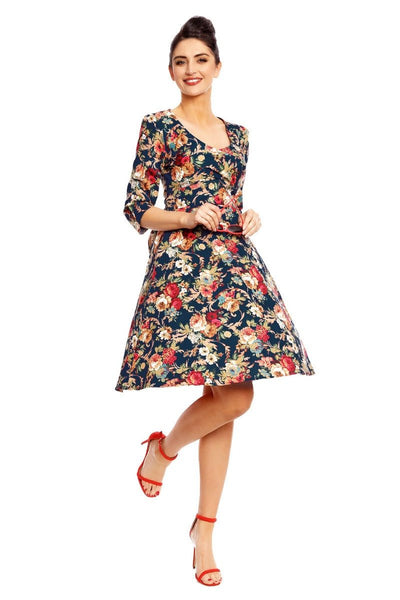 Model wearing our Katherine long sleeved swing dress, in dark blue/red floral print, front view