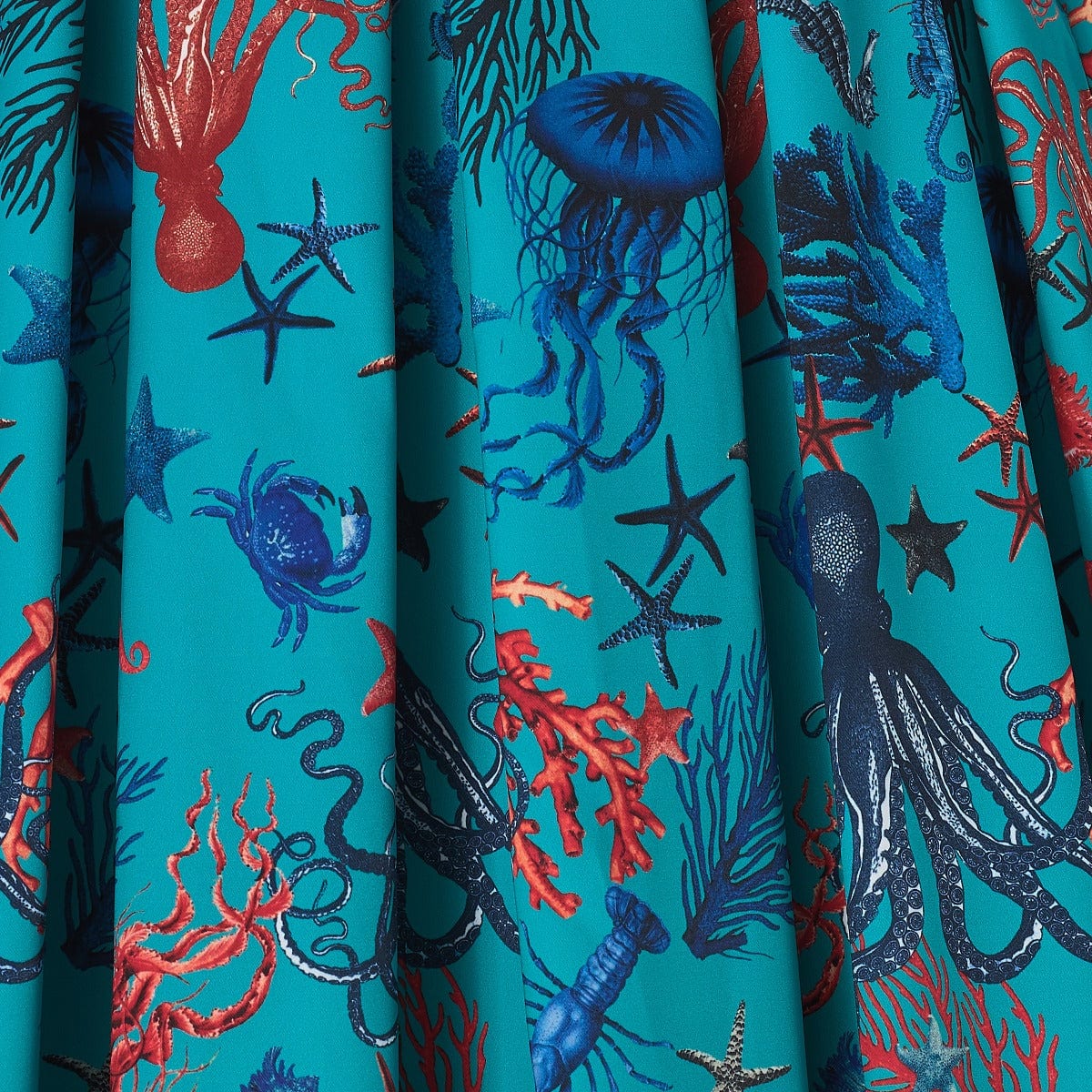 sea blue fabric, with blue and red octopus, squid and jellyfish print