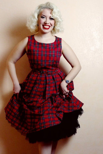 Model wearing red tartan swing dress with petticoat