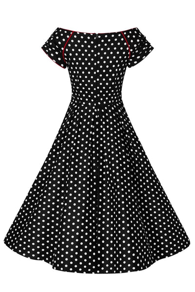 Lily short sleeved swing dress, in black, with white polka dots, back view