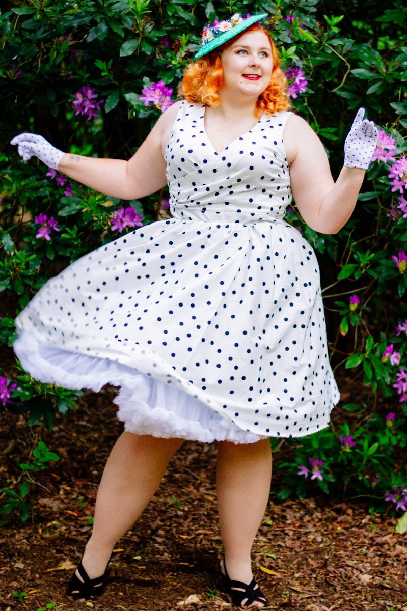 Influencer wearing white dress with black polka dots