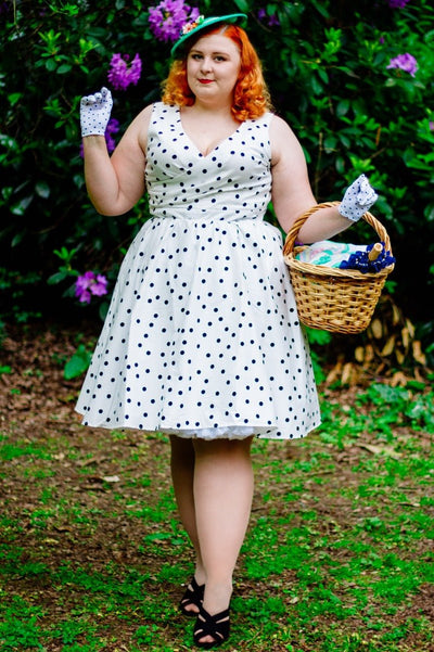 Influencer wearing white dress with black polka dots