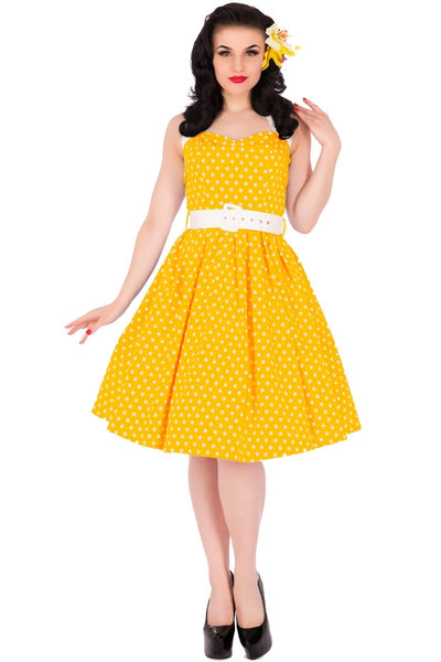Model wearing halterneck retro dress in yellow polka dot print