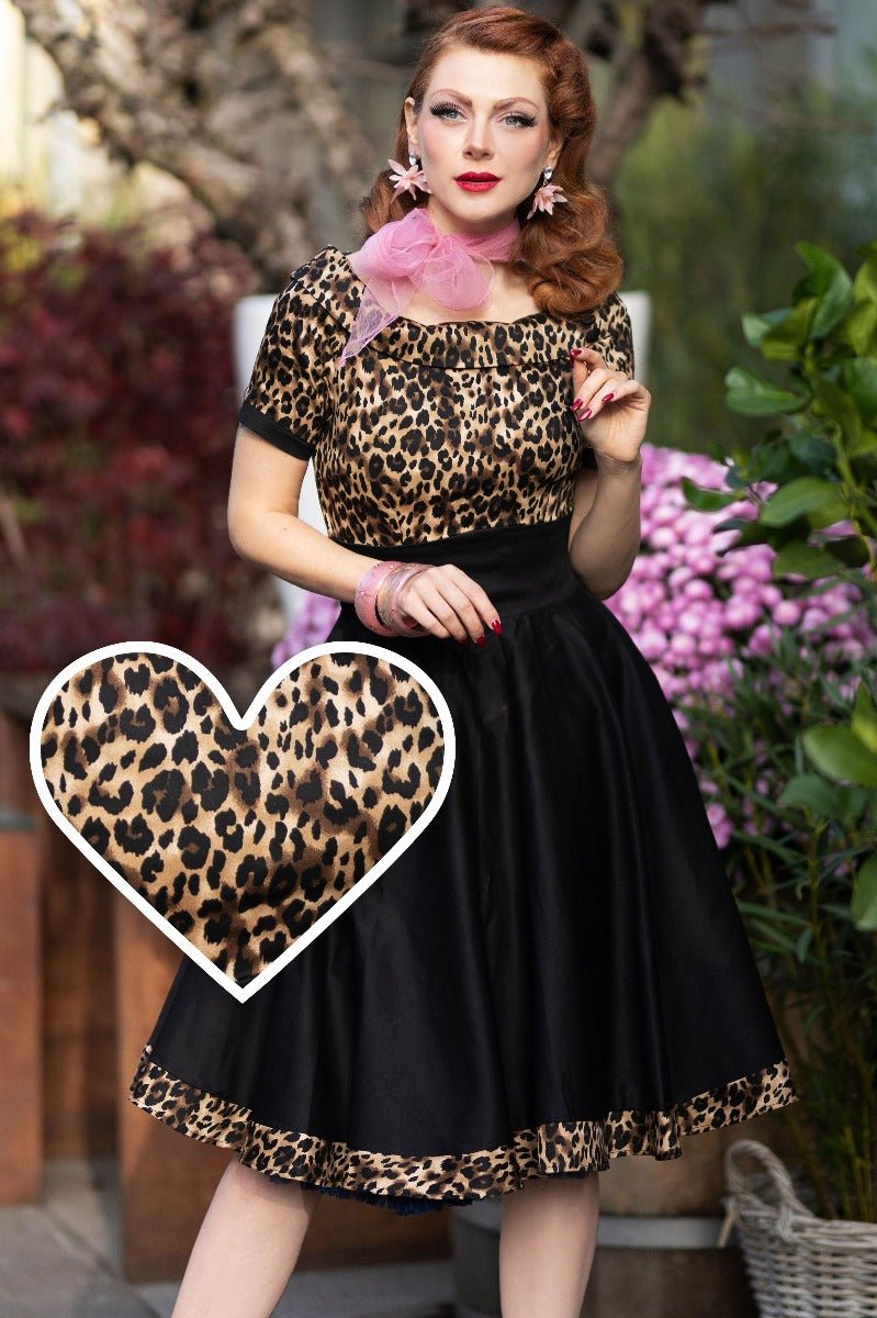 Model wears our short sleeve Darlene dress, with a brown leopard print top and black skirt, with accessories