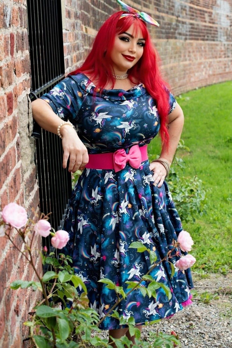 Influencer wearing blue bateau neckline dress with unicorn rainbow print