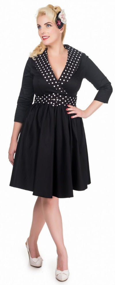 Model wearing black white polka dot collared swing dress