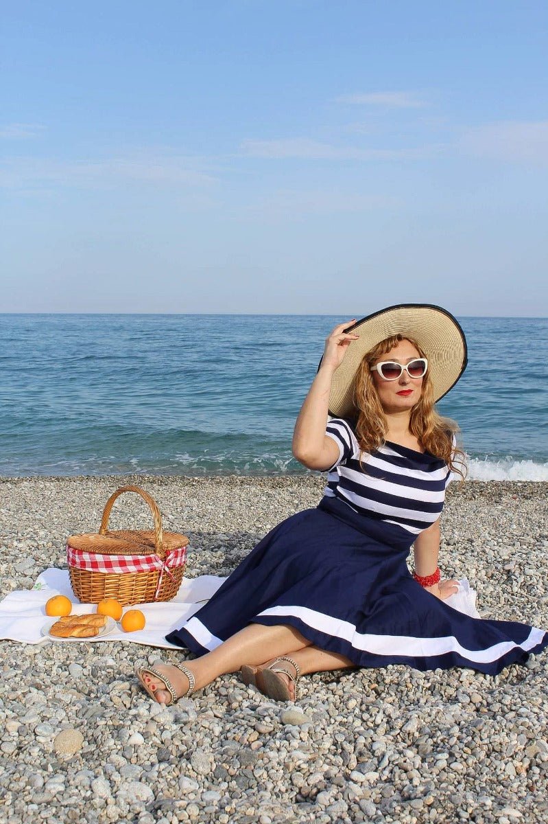 Influencer wearing navy blue/white striped vintage dress on the beach