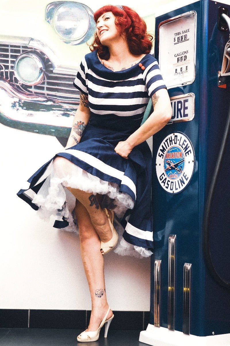 Influencer wearing navy blue/white striped vintage dress with white petticoat
