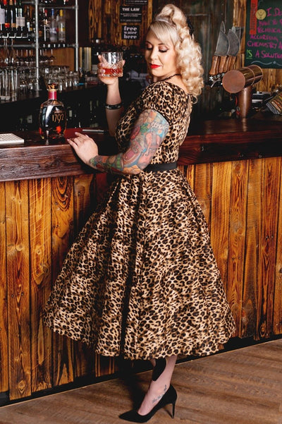 Influencer wearing brown leopard print short sleeve swing dress side view