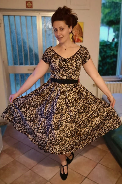 Influencer wearing brown leopard print short sleeve swing dress