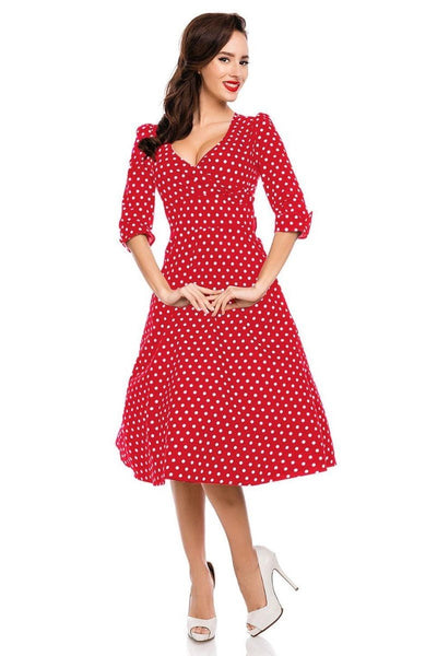 Model wearing red sleeved dress with white polka dots