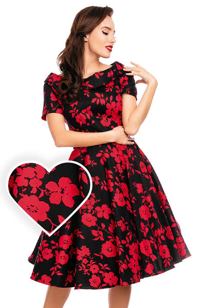 Model wearing our bateau neckline Darlene dress, in black/red floral print, front view